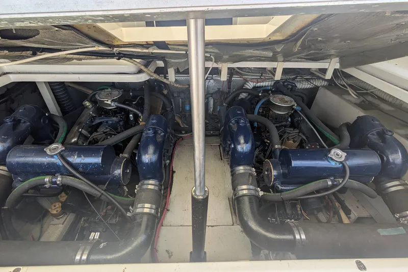 Slide: The Image of Engine compartment of a 1988 Tiara 33 Express boat, showcasing dual engines. - 21