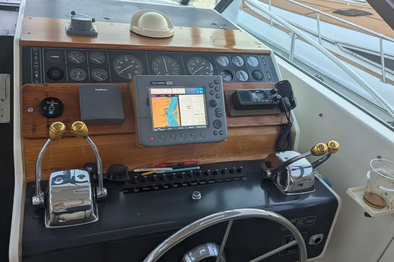 Slide: The Image of 1988 Tiara 33 Express boat dashboard with navigation equipment and controls. - 6