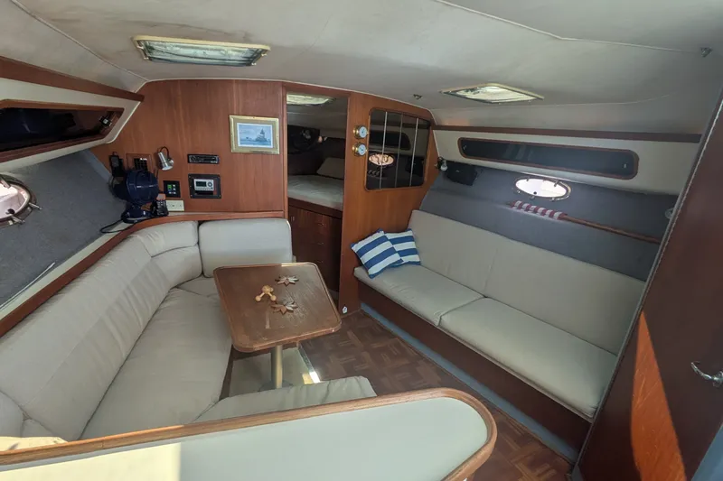 Slide: The Image of Interior of 1988 Tiara 33 Express yacht with cozy seating and wooden accents. - 17