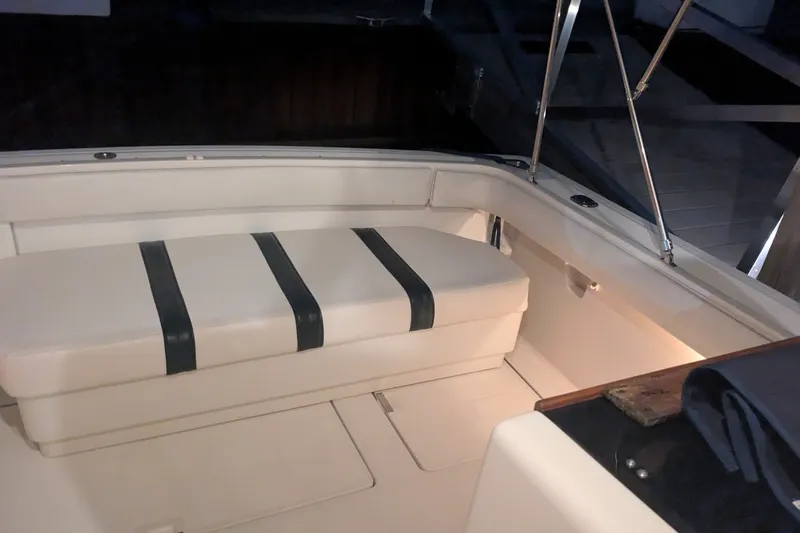 Slide: The Image of 1988 Tiara 33 Express boat interior with cushioned seating and sleek design. - 8