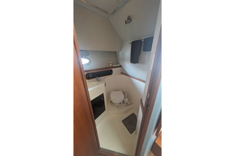 Slide: The Image of 1988 Tiara 33 Express boat bathroom interior with sink, toilet, and towel rack. - 18
