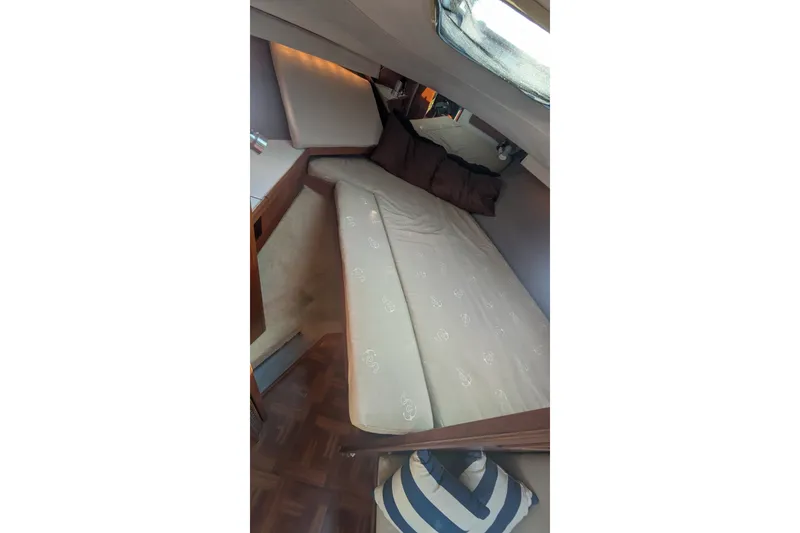 Slide: The Image of Interior cabin of 1988 Tiara 33 Express boat with bed and cushions. - 22