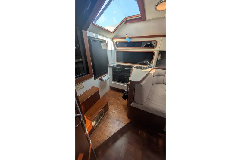 Slide: The Image of Interior of 1988 Tiara 33 Express yacht with kitchen and seating area. - 19