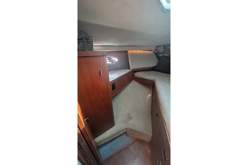 Slide: The Image of Interior cabin of 1988 Tiara 33 Express yacht with wooden cabinetry and cozy seating. - 23