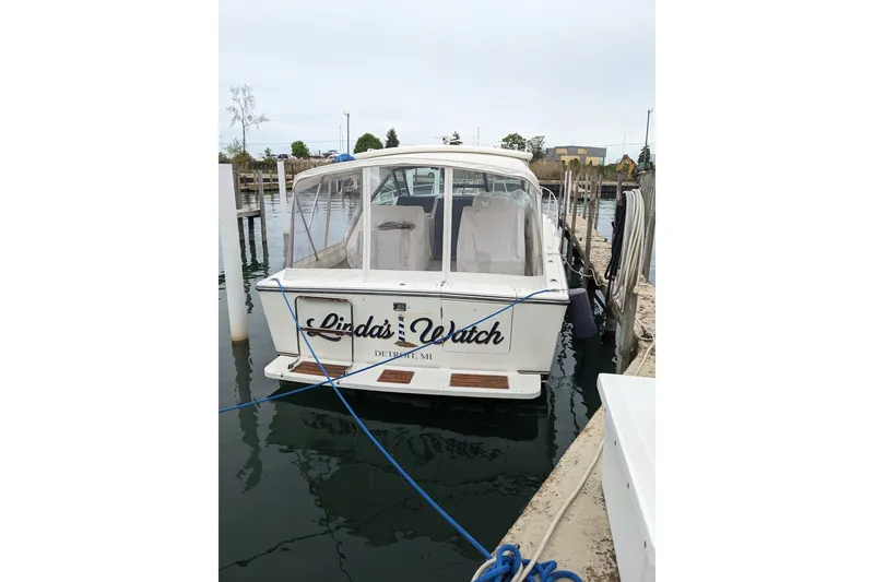 Slide: The Image of 1988 Tiara 33 Express boat docked, named "Linda's Watch," in Detroit marina. - 2