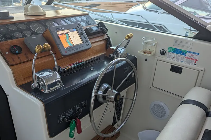 Slide: The Image of Cockpit of 1988 Tiara 33 Express boat with navigation equipment and steering wheel. - 3