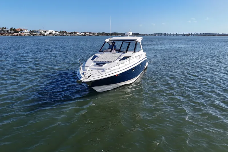 Slide: The Image of 2016 Regal 35 Sport Coupe cruising on a sunny day in open waters. - 79