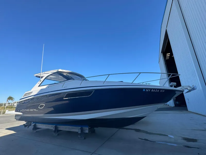 Slide: The Image of 2016 Regal 35 Sport Coupe boat on dry dock near a large warehouse. - 90