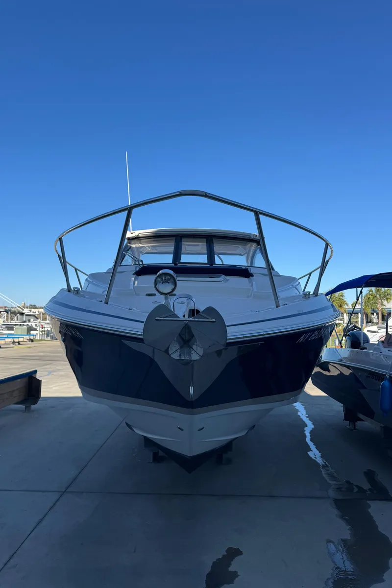 Slide: The Image of 2016 Regal 35 Sport Coupe boat docked under clear blue sky. - 101