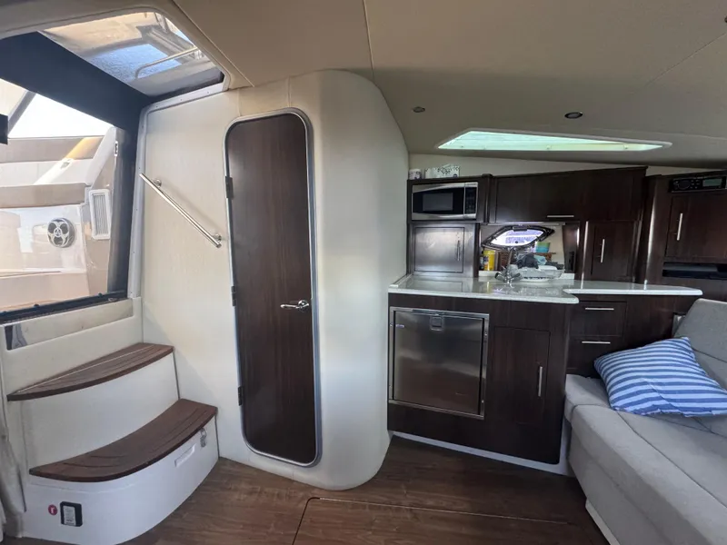 Slide: The Image of Interior of 2016 Regal 35 Sport Coupe with modern kitchen and seating area. - 42