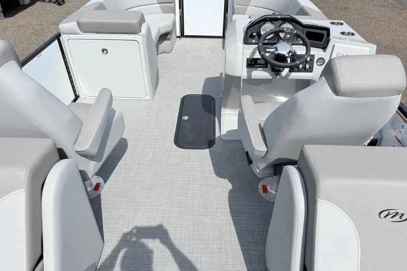 Slide: The Image of Interior of 2026 Manitou Encore boat with modern seating and steering console. - 16