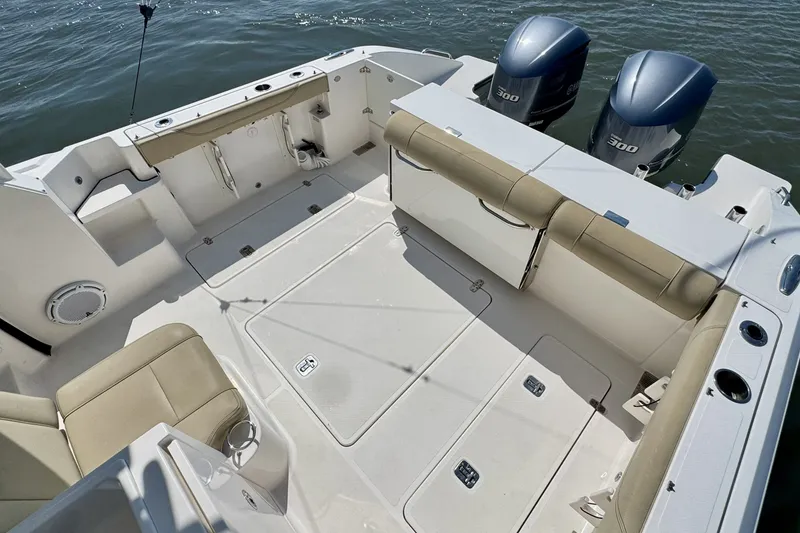 Slide: The Image of 2017 Pursuit OS 325 Offshore boat deck with seating and twin engines. - 13