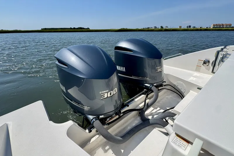 Slide: The Image of 2017 Pursuit OS 325 Offshore boat with twin Yamaha 300 engines on water. - 15