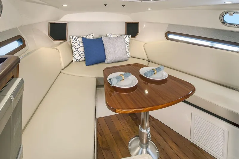 Slide: The Image of Manufacturer Provided Image: 2017 Pursuit OS 325 Offshore cabin with dining table and cushioned seating. - 20