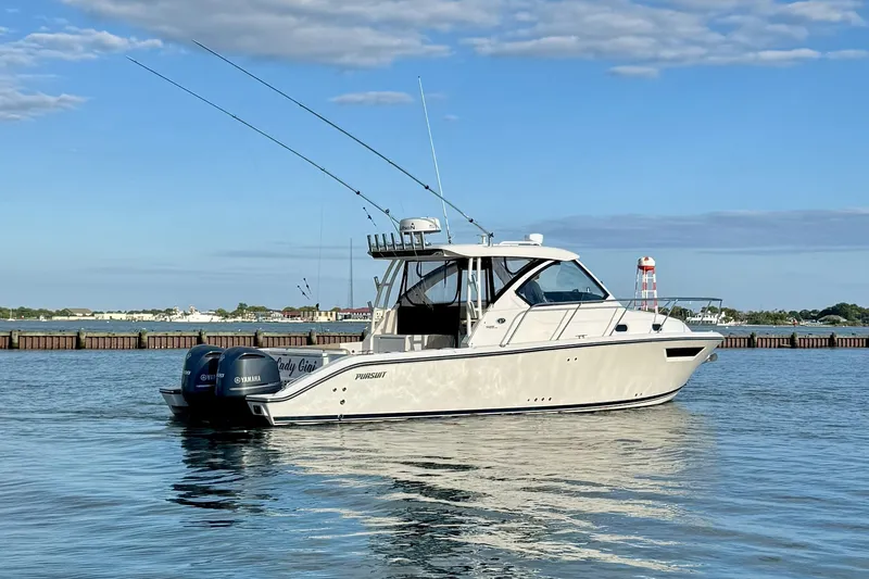 Slide: The Image of 2017 Pursuit OS 325 Offshore boat on calm water under blue sky. - 3