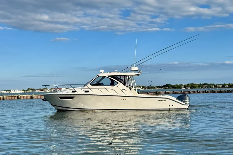 The Image of 2017 Pursuit OS 325 Offshore boat on calm water under blue sky. - 0