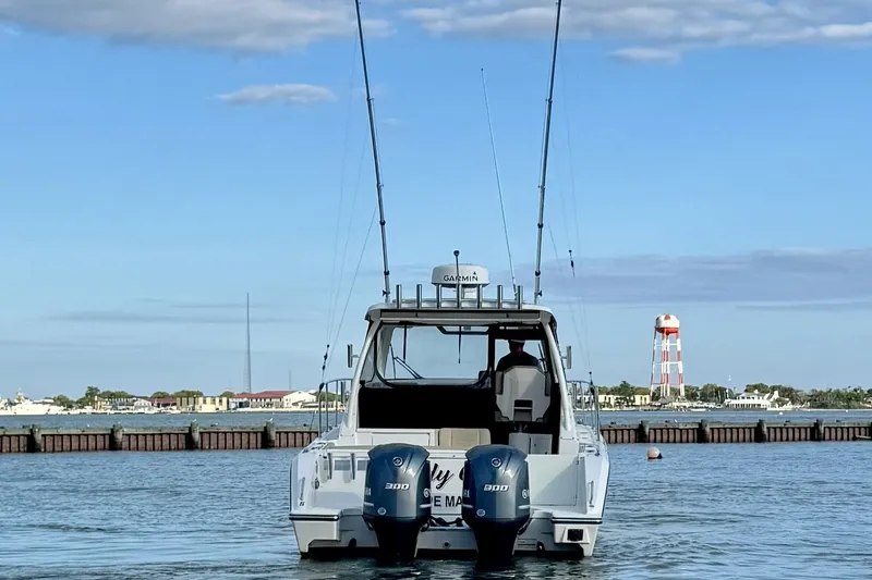 Slide: The Image of 2017 Pursuit OS 325 Offshore boat with dual engines on calm water. - 4