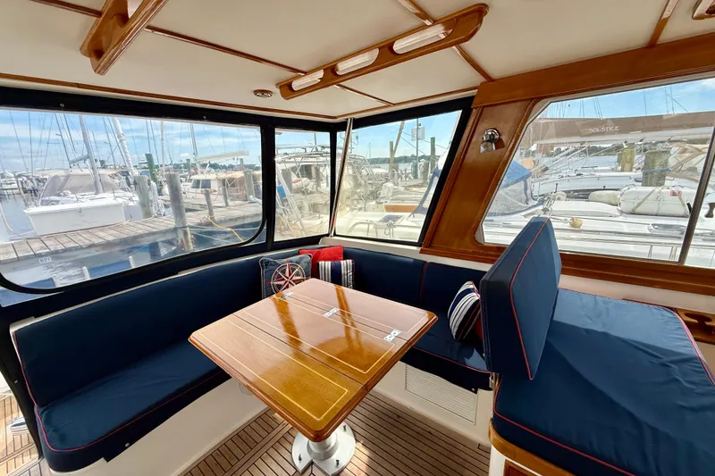 Slide: The Image of Interior of 2001 Grand Banks 49 Eastbay HX yacht with wooden table and blue seating. - 67