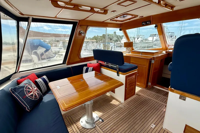 Slide: The Image of Interior of 2001 Grand Banks 49 Eastbay HX yacht with wooden table and blue seating. - 70