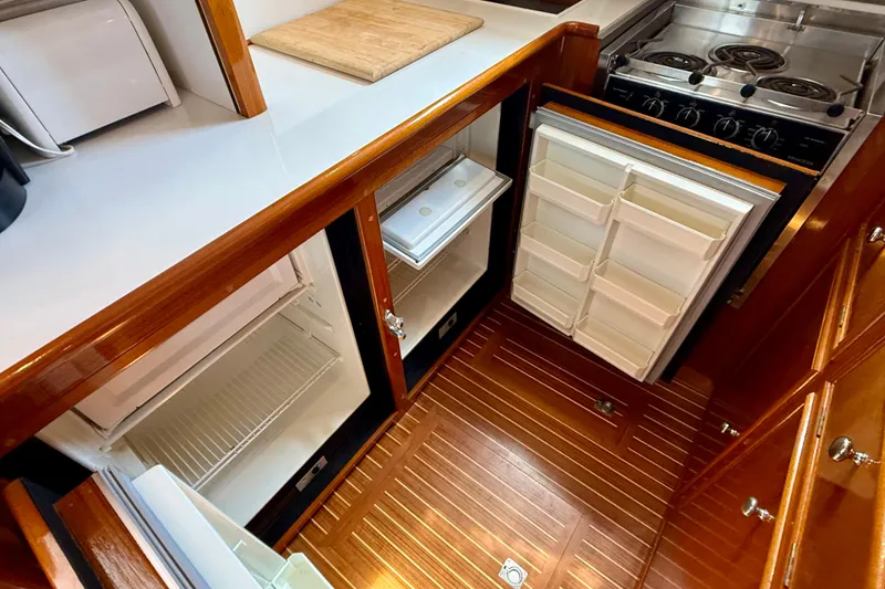 Slide: The Image of Galley kitchen in 2001 Grand Banks 49 Eastbay HX with wood flooring and appliances. - 56