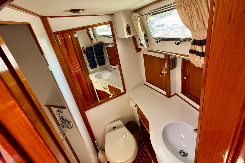 Slide: The Image of Luxurious 2001 Grand Banks 49 Eastbay HX yacht bathroom with wood accents and modern fixtures. - 41