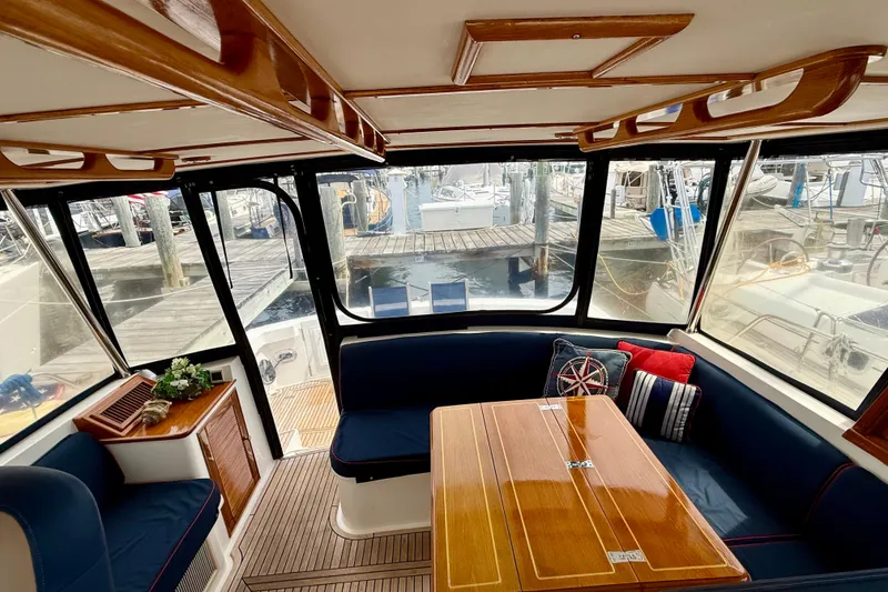 Slide: The Image of Interior of 2001 Grand Banks 49 Eastbay HX yacht with elegant wood finish and marina view. - 69