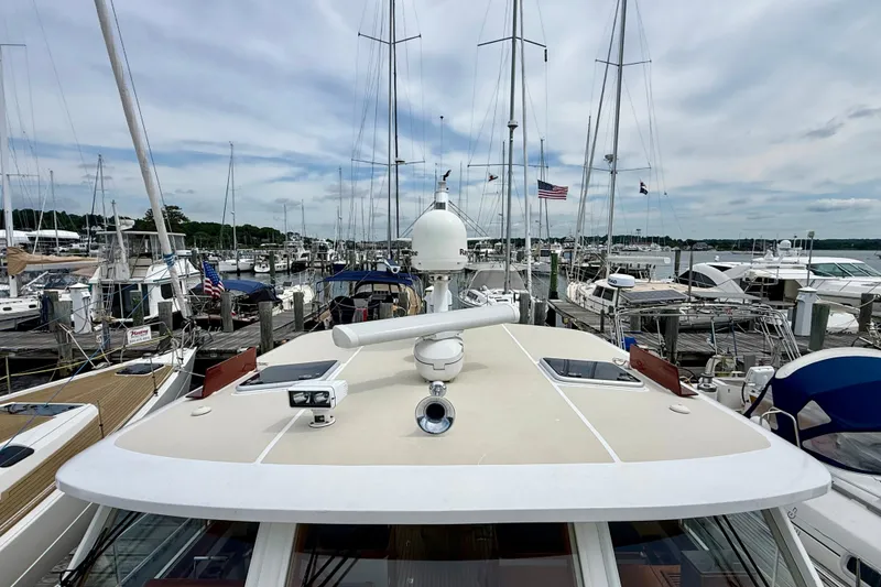 Slide: The Image of 2001 Grand Banks 49 Eastbay HX yacht docked in a marina with sailboats. - 26