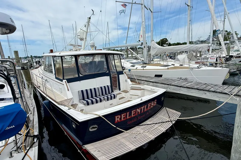 Slide: The Image of 2001 Grand Banks 49 Eastbay HX yacht docked at marina with sailboats. - 13