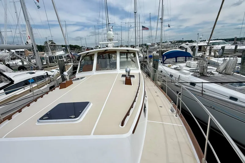 Slide: The Image of 2001 Grand Banks 49 Eastbay HX yacht docked among sailboats at a marina. - 23
