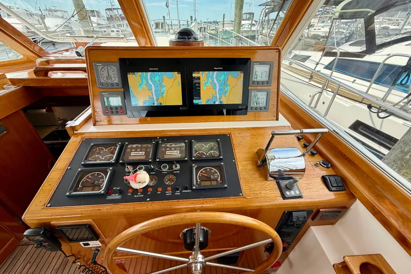 Slide: The Image of Helm of 2001 Grand Banks 49 Eastbay HX with navigation screens and controls. - 61