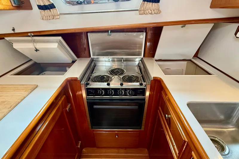 Slide: The Image of Galley kitchen in 2001 Grand Banks 49 Eastbay HX yacht with stove and sink. - 54