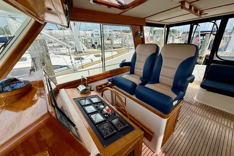 Slide: The Image of Interior of 2001 Grand Banks 49 Eastbay HX yacht with dual captain's chairs and control panel. - 59