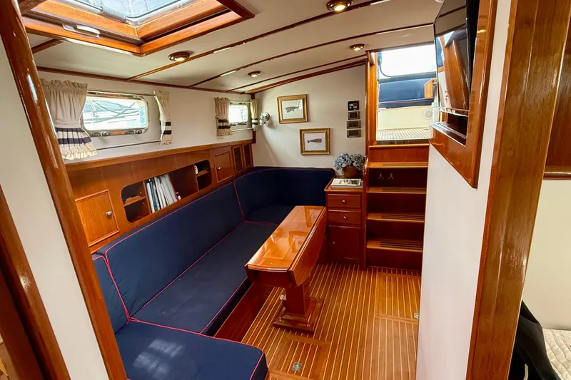 Slide: The Image of Luxurious 2001 Grand Banks 49 Eastbay HX yacht interior with elegant wood finishes and cozy seating. - 49