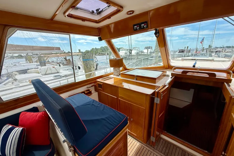 Slide: The Image of Interior of 2001 Grand Banks 49 Eastbay HX yacht with wooden finish and marina view. - 65