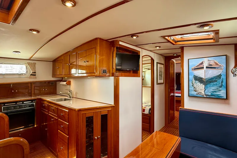Slide: The Image of Luxurious 2001 Grand Banks 49 Eastbay HX yacht interior with elegant wood cabinetry and modern amenities. - 51