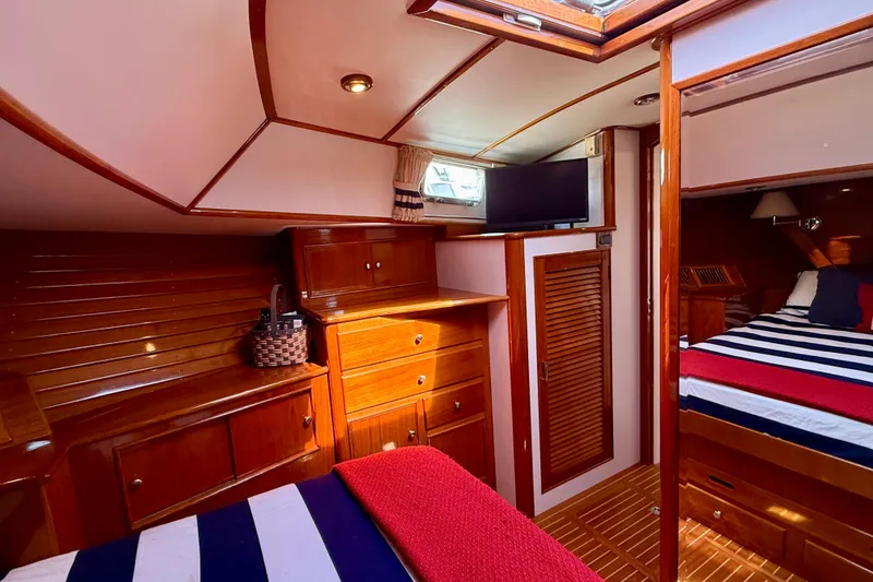 Slide: The Image of Luxurious 2001 Grand Banks 49 Eastbay HX yacht interior with wood cabinetry and cozy bedding. - 36