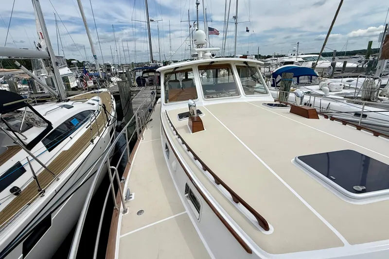 Slide: The Image of 2001 Grand Banks 49 Eastbay HX yacht docked among sailboats at a marina. - 24