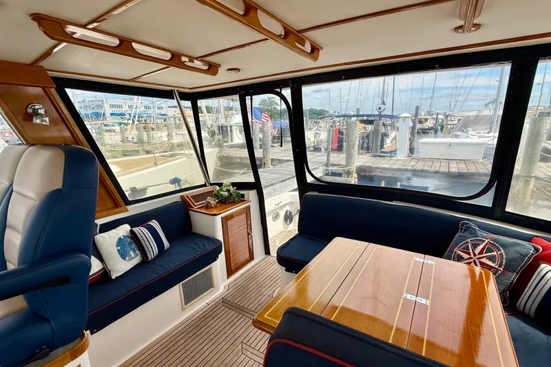 Slide: The Image of Interior of 2001 Grand Banks 49 Eastbay HX yacht with elegant seating and wooden table. - 68