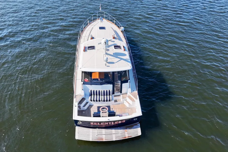 Slide: The Image of 2001 Grand Banks 49 Eastbay HX yacht on open water, aerial view. - 7