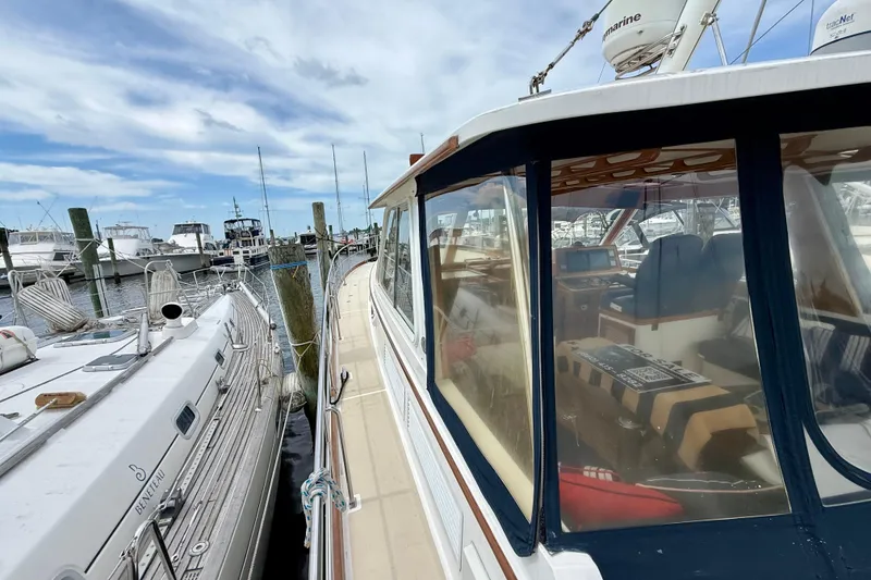 Slide: The Image of 2001 Grand Banks 49 Eastbay HX yacht docked at marina, clear sky background. - 19