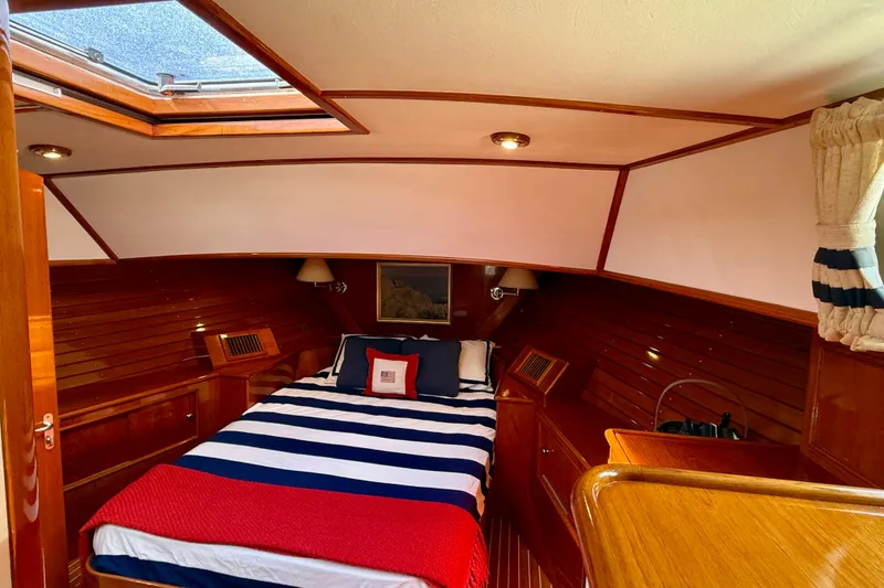 Slide: The Image of Luxurious cabin interior of 2001 Grand Banks 49 Eastbay HX yacht with striped bedding. - 34