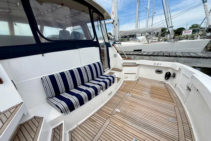 Slide: The Image of 2001 Grand Banks 49 Eastbay HX yacht with striped seating and teak deck. - 16