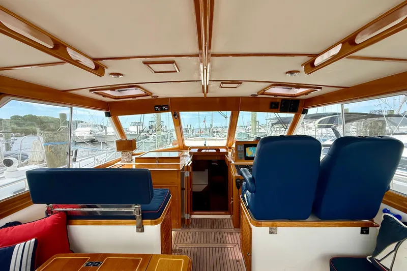 Slide: The Image of Interior of 2001 Grand Banks 49 Eastbay HX yacht with blue seating and wooden accents. - 66