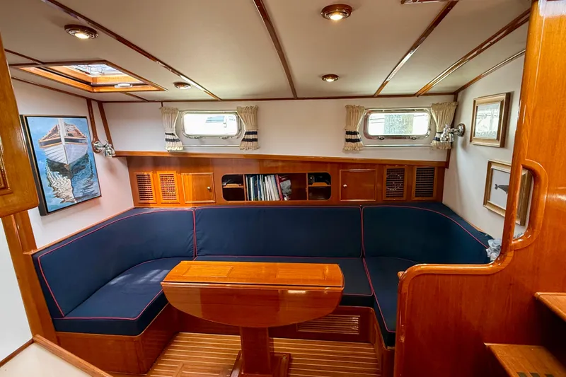 Slide: The Image of Luxurious 2001 Grand Banks 49 Eastbay HX yacht interior with elegant wood finish and cozy seating. - 50