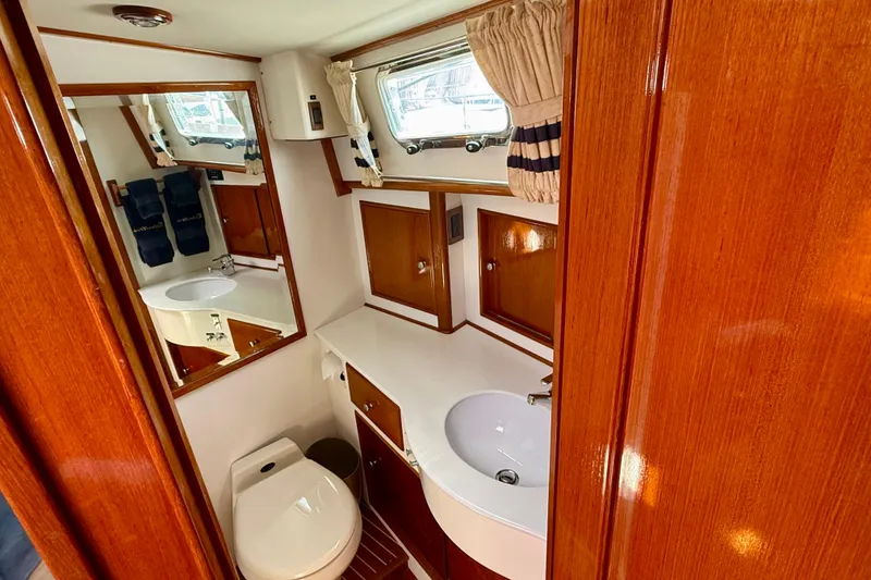 Slide: The Image of Luxurious 2001 Grand Banks 49 Eastbay HX yacht bathroom with wood accents and modern fixtures. - 39