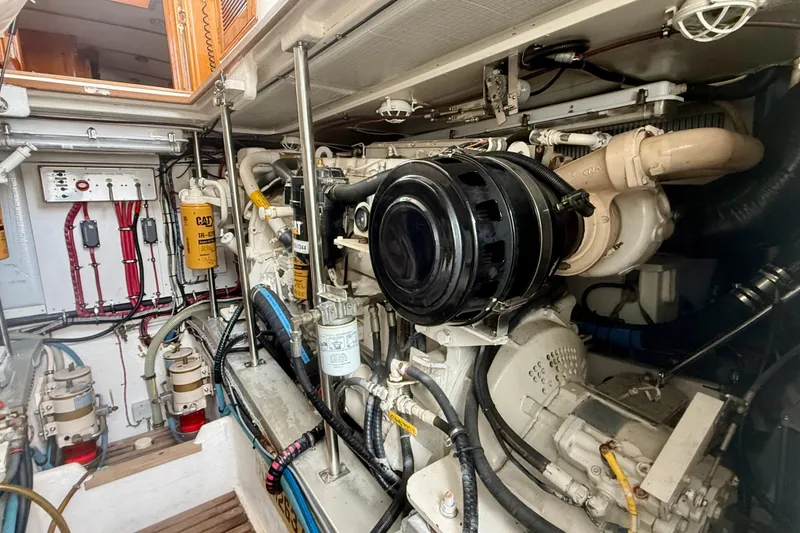 Slide: The Image of Engine room of a 2001 Grand Banks 49 Eastbay HX, showcasing detailed machinery and components. - 29