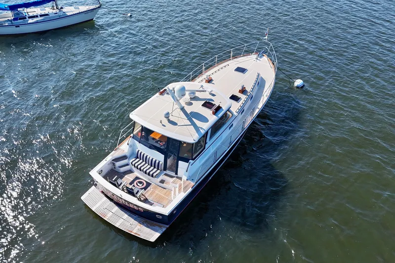 Slide: The Image of 2001 Grand Banks 49 Eastbay HX yacht on open water, aerial view. - 8