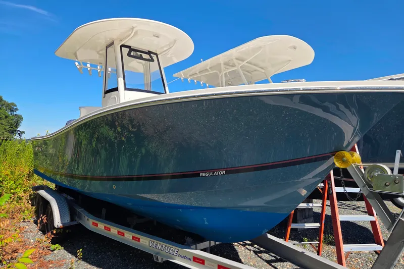 The Image of 2020 Regulator 23 Forward Seating boat on trailer under clear blue sky. - 0