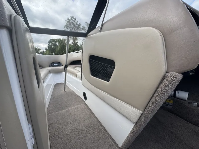 Slide: The Image of Interior of a 2007 Malibu Wakesetter 23 LSV with beige seating and carpeted flooring. - 21
