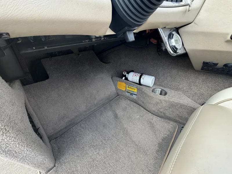 Slide: The Image of Interior of a 2007 Malibu Wakesetter 23 LSV with carpeted flooring and a fire extinguisher. - 20